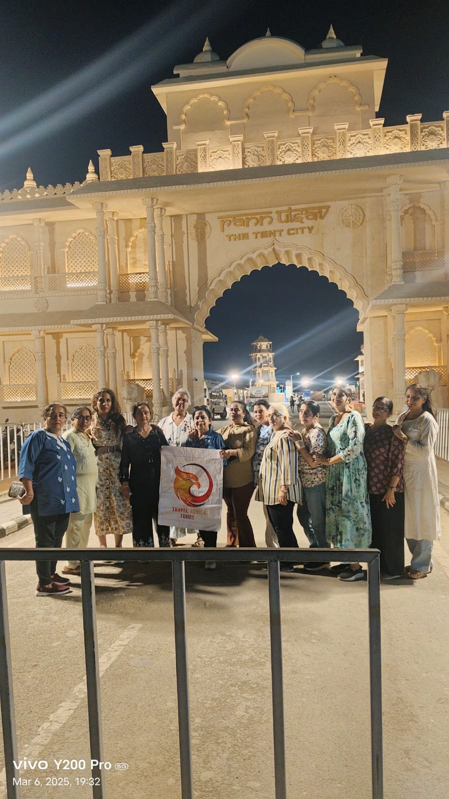 Travel Aguila tour group at the illuminated grand entrance of Dhordo Tent City