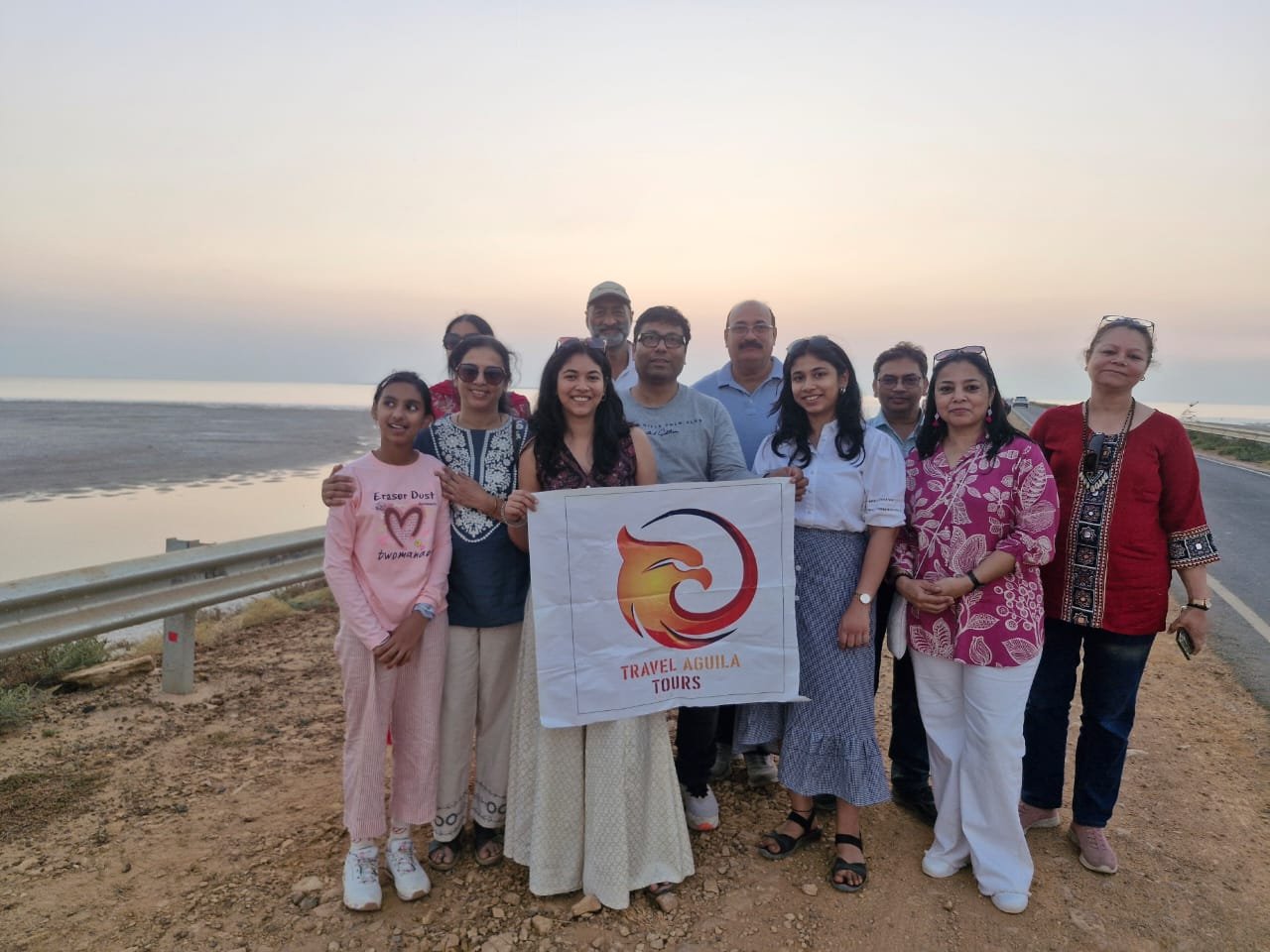 Travel Aguila group banner photo during golden hour sunset across the desert highway