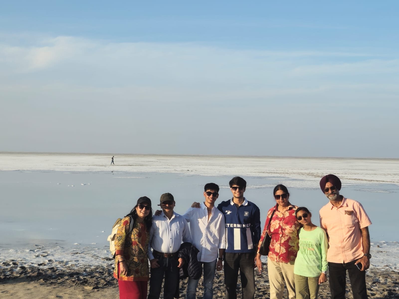 Tourists posing on the endless white salt flat horizon of Rann of Kutch